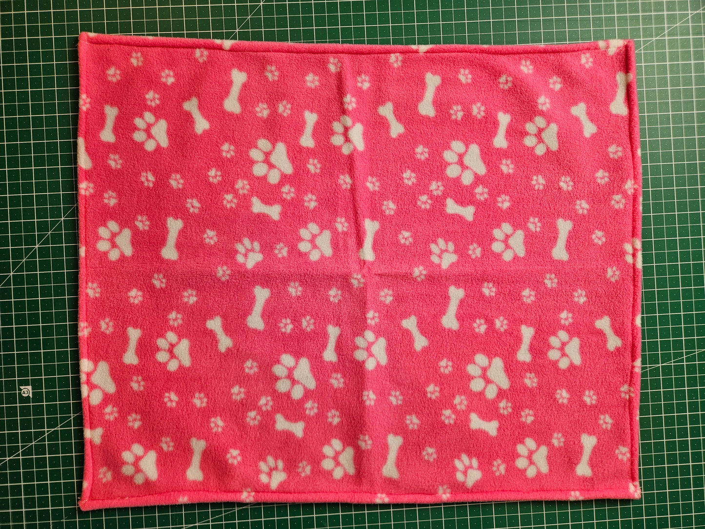 Little Pet Blanket. Dog theme Anti Pill Polar Fleece Fabric with paw and bones prints. Selection of pink or black background