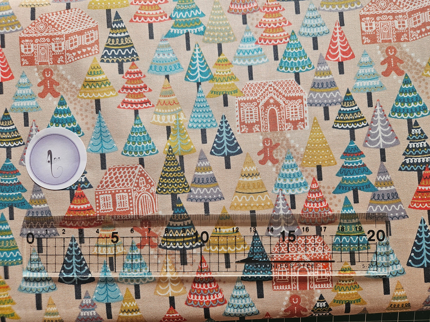 Patterned fabric with a ruler for scale on a beige background