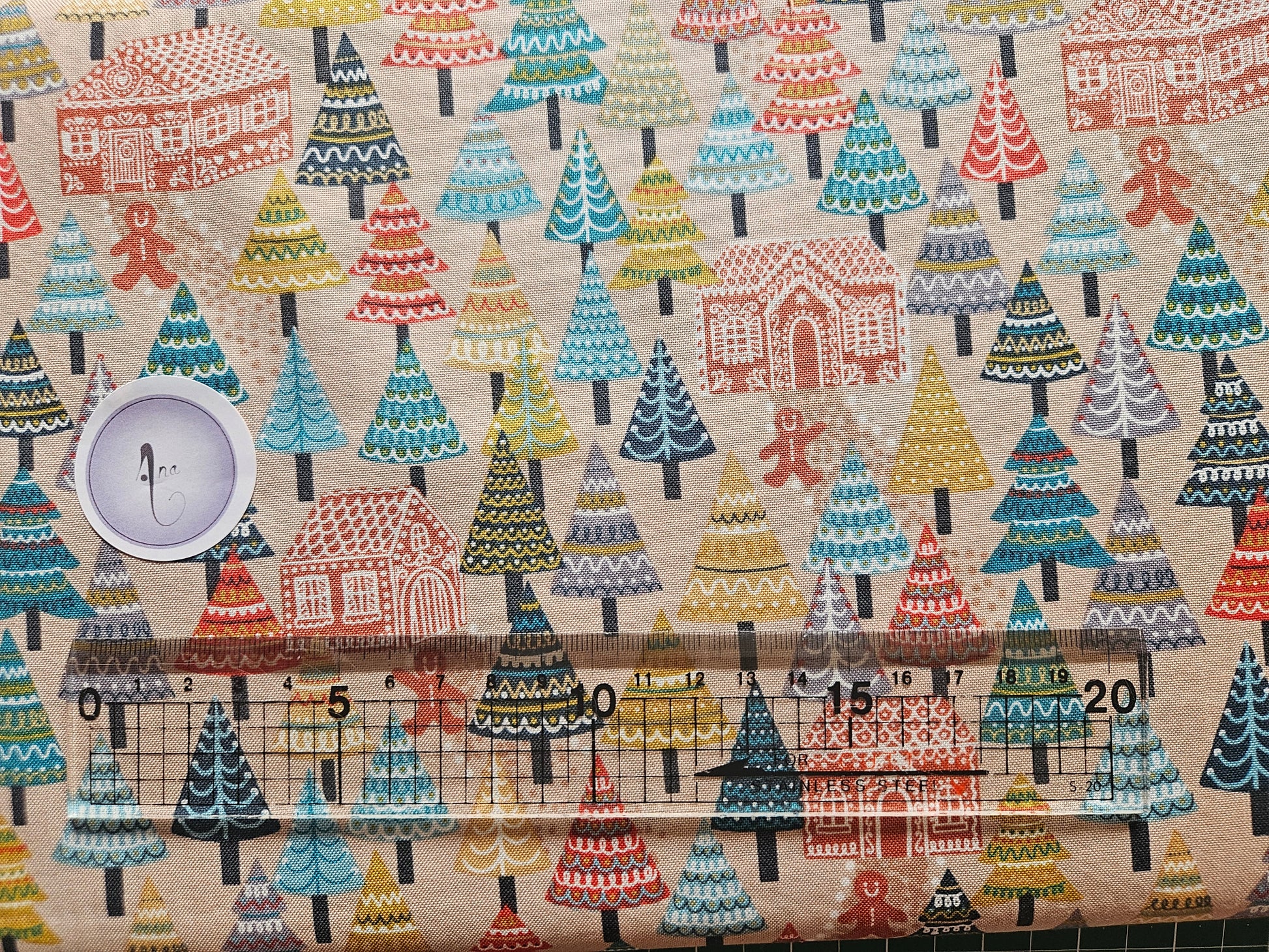 Patterned fabric with a ruler for scale on a beige background