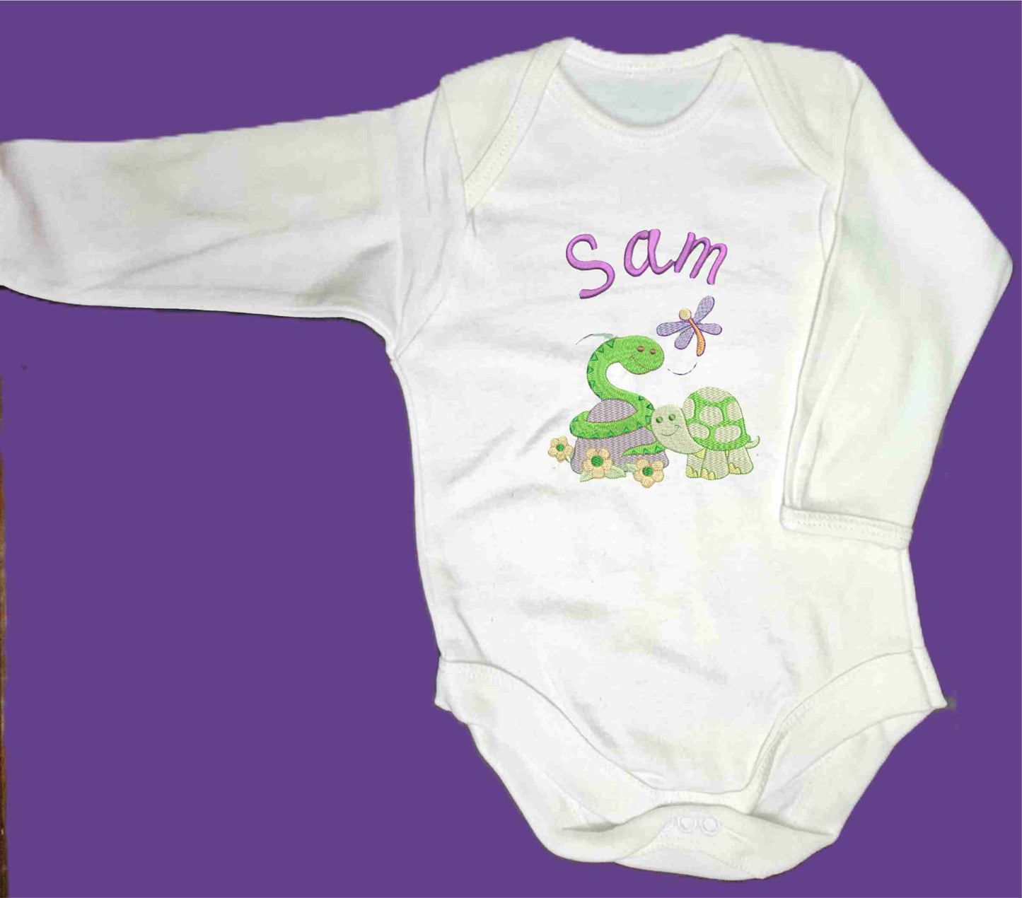 Personalised Baby Snake and Baby Turtle enjoying the spring with their little Dragonfly friend.  Design Embroidered on Organic Cotton Long and Short Sleeve Baby Bodysuit. Comfortable and soft.